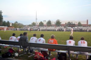 Rockville players watch the game intently from the sideline.