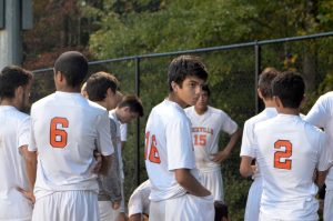 Senior Kevin Pereira and teammates gather after the game.