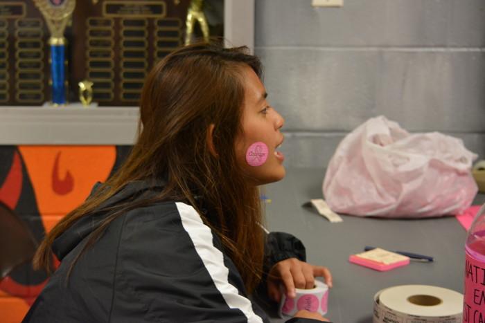 Senior Grace Cajayon asks for donations. All donations from the game go towards breast cancer research.