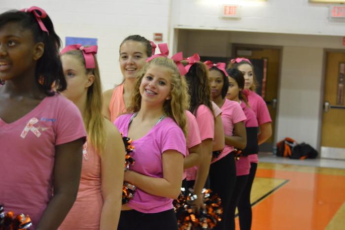 Cheerleaders stand for the national anthem. 