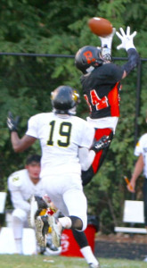 Senior Mickey Vangeison jumps over Richard Montgomery player to make the catch.