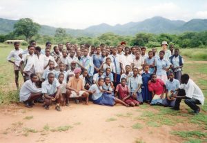 Mark Bradley poses with high school students while serving in Zimbabwe. Photo Courtesy of Mark Bradley